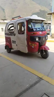 a small van is parked on the street at Hospedaje Quillabamba in Santa Teresa