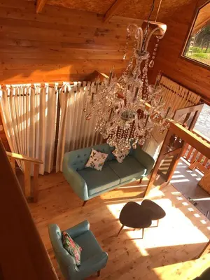 an overhead view of a living room with a chandelier at Cabañas - Kobold Haus in Oxapampa