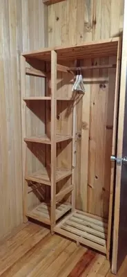 a wooden book shelf in a corner of a room at Oxablues Home Lodge in Oxapampa