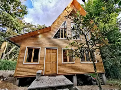 a tiny house on a bench in front of a house at Oxablues Home Lodge in Oxapampa