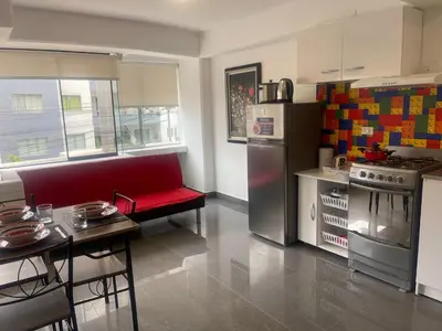 a kitchen with a red couch and a refrigerator at (10) Departamento de estreno centro de Mirafores in Lima