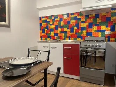 a kitchen with a table and a colorful wall at 13 Nuevo y acogedor departamento en Miraflores in Lima