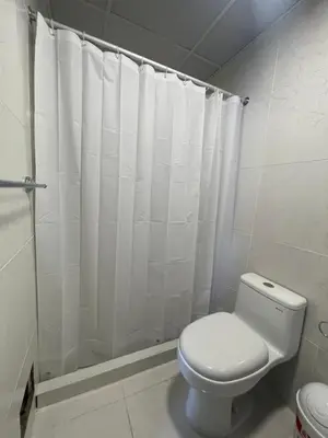 a bathroom with a toilet and a shower curtain at 13 Nuevo y acogedor departamento en Miraflores in Lima
