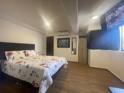 a bedroom with a bed and a large window at 15 Acogedor dpto de un ambiente en miraflores in Lima