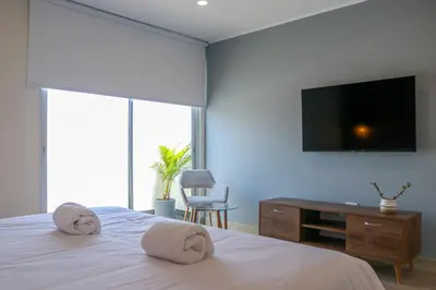a bedroom with a bed with two pillows on it at Black by Wynwood House in Lima