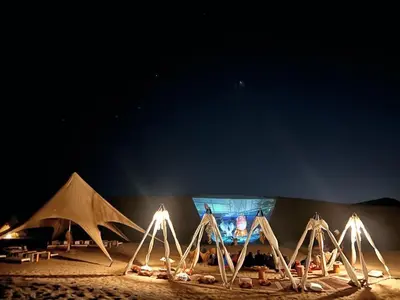 a group of tents on the beach at night at Duna Camp Huacachina in Ica