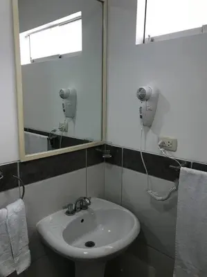 a bathroom with a sink and a mirror at Confortable and functional apartment in MIRAFLORES ! in Lima