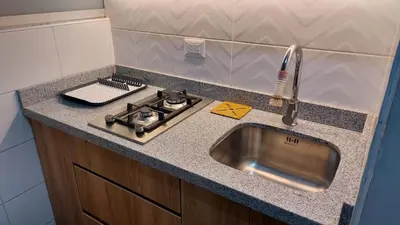 a kitchen counter with a sink and a stove at Confortable and functional apartment in MIRAFLORES ! in Lima
