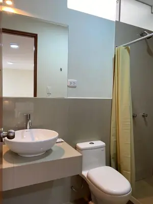 a bathroom with a sink and a toilet and a mirror at Hotel Alba in Ica
