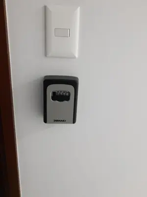 a clock on the side of a white wall at Encantador apartamento en Miraflores in Lima