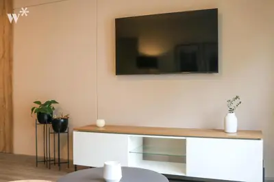 a living room with a tv on a wall at Solar by Wynwood House in Lima