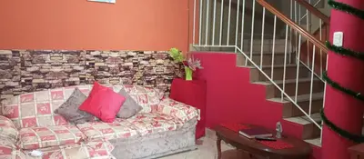 a living room with a couch with pink pillows at Departamento 6p Tierra del Sol Eterno - Ica centro in Ica