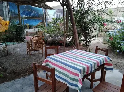 a table and chairs with a striped table cloth on it at Departamento 6p Tierra del Sol Eterno - Ica centro in Ica