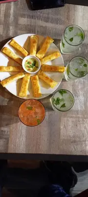a plate with french fries and sauce on a table at COSMOPOLITAN INN in Ventanilla