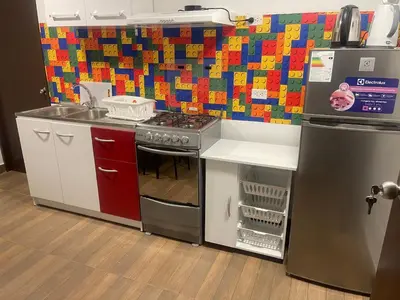 a toy kitchen with a stove and a refrigerator at 18 Departamento en la mejor zona de Miraflores in Lima