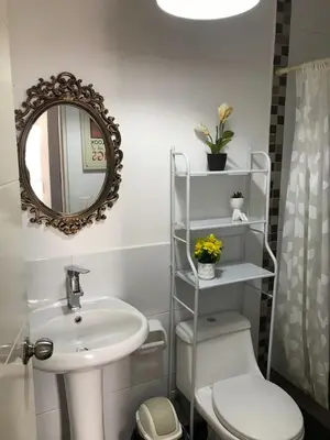 a bathroom with a sink and a toilet and a mirror at Hermoso Departamento en Guardia Civil - Chorrillos in Lima