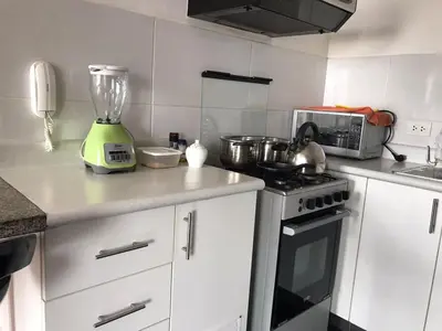 a kitchen with a blender sitting on a counter at Hermoso Departamento en Guardia Civil - Chorrillos in Lima
