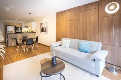 a living room with a couch and a table at Alcanfores 1262 by Wynwood House in Lima