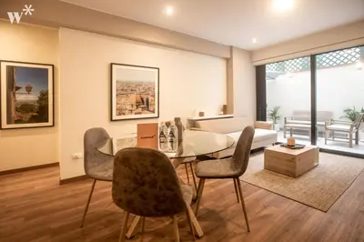 a living room with a dining table and chairs at Alcanfores 1262 by Wynwood House in Lima