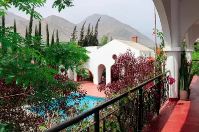 a view of a house with mountains in the background at Casa Hotel Mamaluna in Lunahuaná