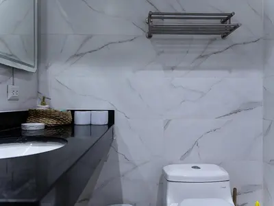 a white bathroom with a toilet and a sink at Apartment in Center of Miraflores in Lima