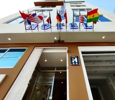 a building with flags on the side of it at Cesars Hotel Lima in Lima