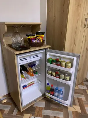 a small refrigerator with its door open in a kitchen at Cesars Hotel Lima in Lima