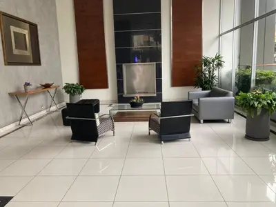a lobby with chairs and a tv in a building at Book in Miraflores - Lima in Lima