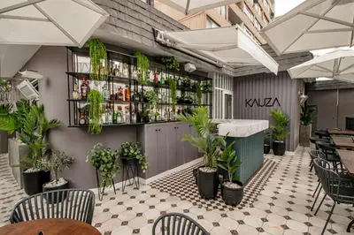a restaurant with plants on the wall and a bar at TARATA BOUTIQUE HOTEL in Lima