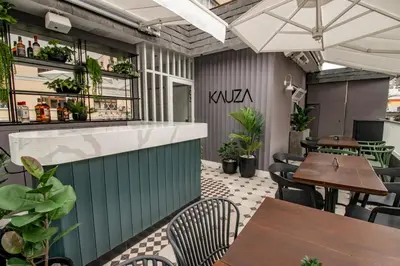 an outdoor patio with tables and chairs and a kuka restaurant at TARATA BOUTIQUE HOTEL in Lima