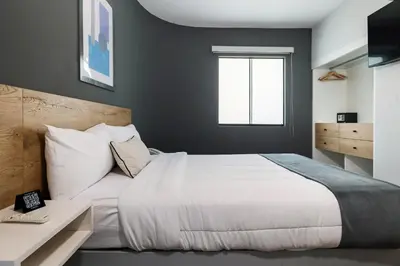 a bedroom with a white bed and a window at TARATA BOUTIQUE HOTEL in Lima