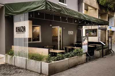 a restaurant with a green awning on a street at TARATA BOUTIQUE HOTEL in Lima
