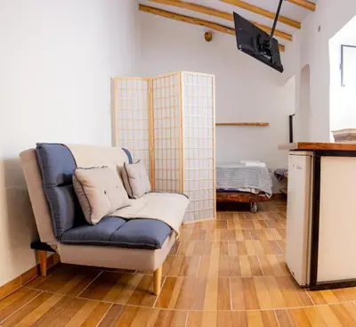 a living room with a couch and a tv at Santo Domingo in Ayacucho