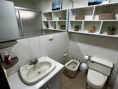 a bathroom with a sink and a toilet at Bonito depa san isidro cama queen home office wifi y cochera in Lima