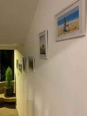a hallway with pictures on the walls of a house at VIVEMAR PUNTA HERMOSA - Beach House Lima - Perú in Punta Hermosa