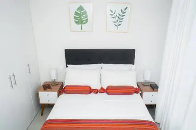 a bedroom with a bed with two pillows on it at Hermoso departamento de 3 habitaciones in Lima