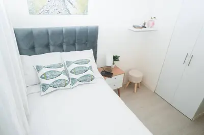 a bedroom with a bed with a gray headboard at Hermoso departamento de 3 habitaciones in Lima