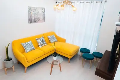 a living room with a yellow couch and chairs at Hermoso departamento de 3 habitaciones in Lima