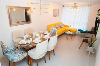 a living room with a table and a yellow couch at Hermoso departamento de 3 habitaciones in Lima