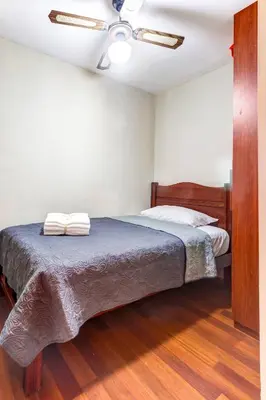 a bedroom with a bed with two towels on it at Apartamentos Estela en Alameda colonial - 5km Aeropuerto Jorge Chávez in Lima