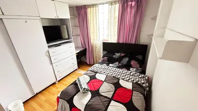 a small bedroom with a bed and a tv at II Habitación Privada en Miraflores Central City in Lima