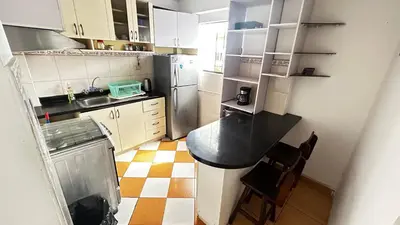 a small kitchen with a counter and a refrigerator at II Habitación Privada en Miraflores Central City in Lima