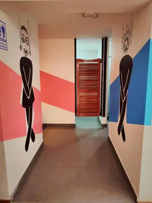 a hallway with colorful walls and a door at Magic Packer Hostel in Cusco