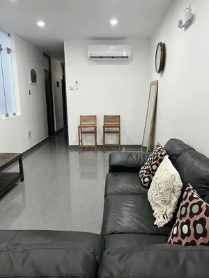 a black leather couch in a living room at MH Apartments Ica 3 in Ica