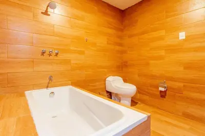 a bathroom with a white tub and a toilet at Suite Panorámico 304 in Urubamba