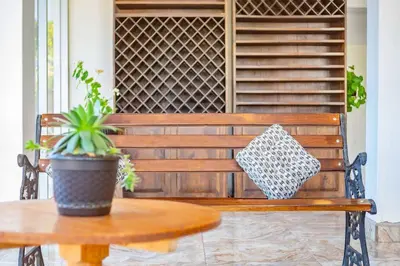 a wooden bench with a potted plant on a table at Suite Panorámico 304 in Urubamba