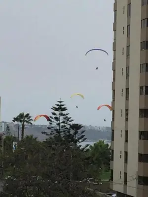 a group of kites flying in the sky near a building at Smart Home Away Apartment in Lima