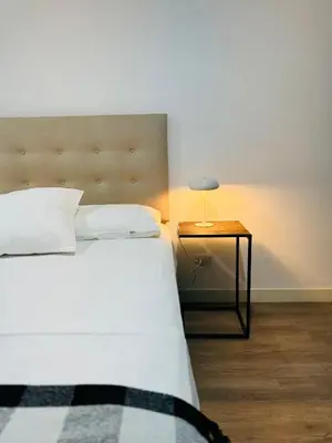 a bedroom with a bed and a table with a lamp at Amazing 2BR in Barranco in front of CENTRAL restaurant in Lima