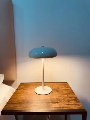 a blue chair sitting on top of a wooden table at Amazing 2BR in Barranco in front of CENTRAL restaurant in Lima