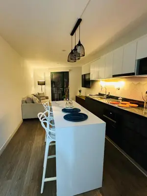 a kitchen with a white island in a room at Amazing 2BR in Barranco in front of CENTRAL restaurant in Lima